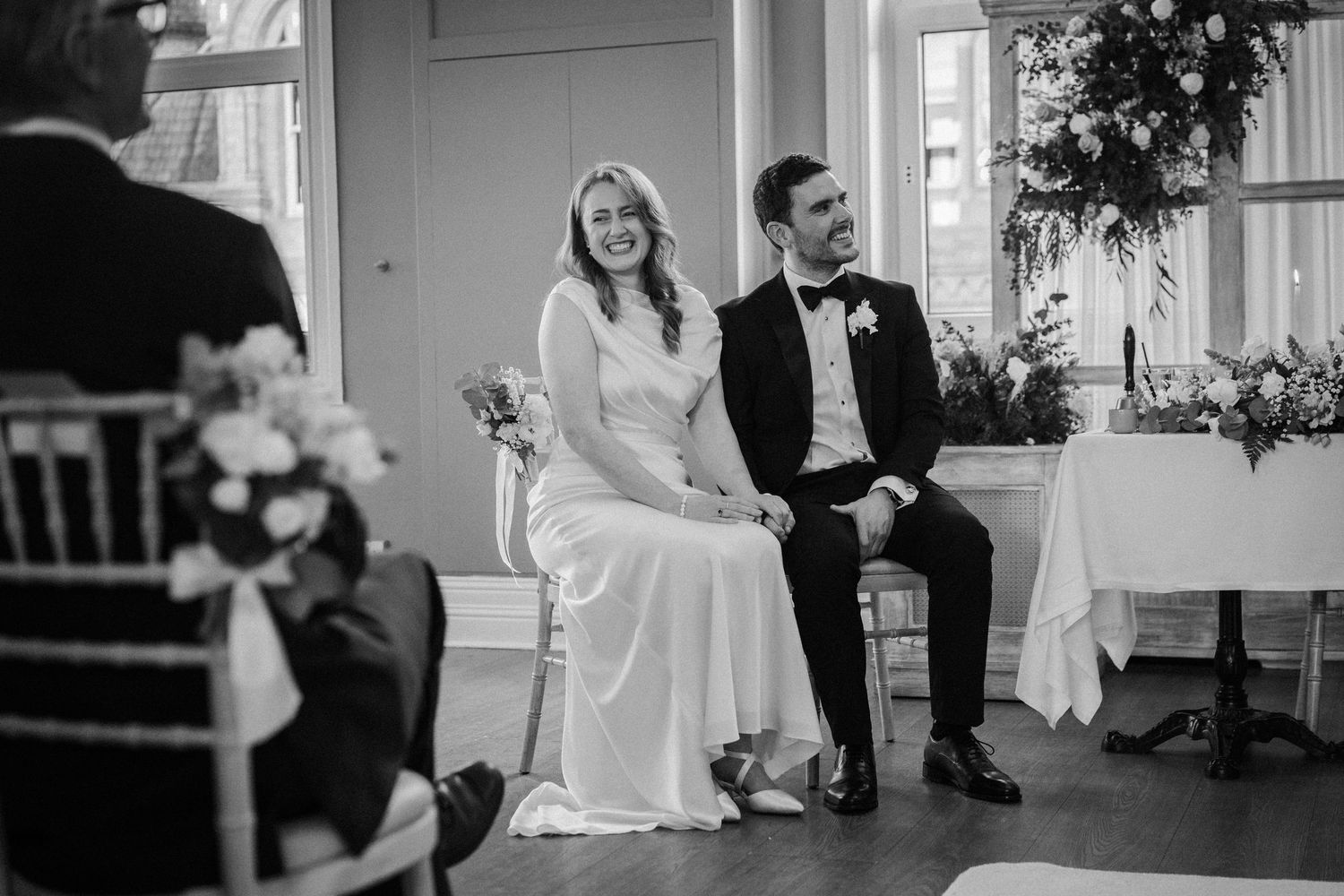 Black and white wedding photo collage showing candid moments between newlyweds during their celebration.