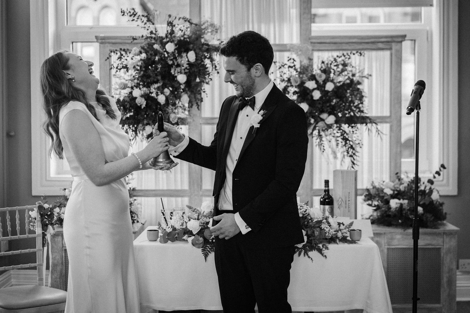 A series of romantic black and white wedding photos showing intimate moments between the bride and groom at a venue.