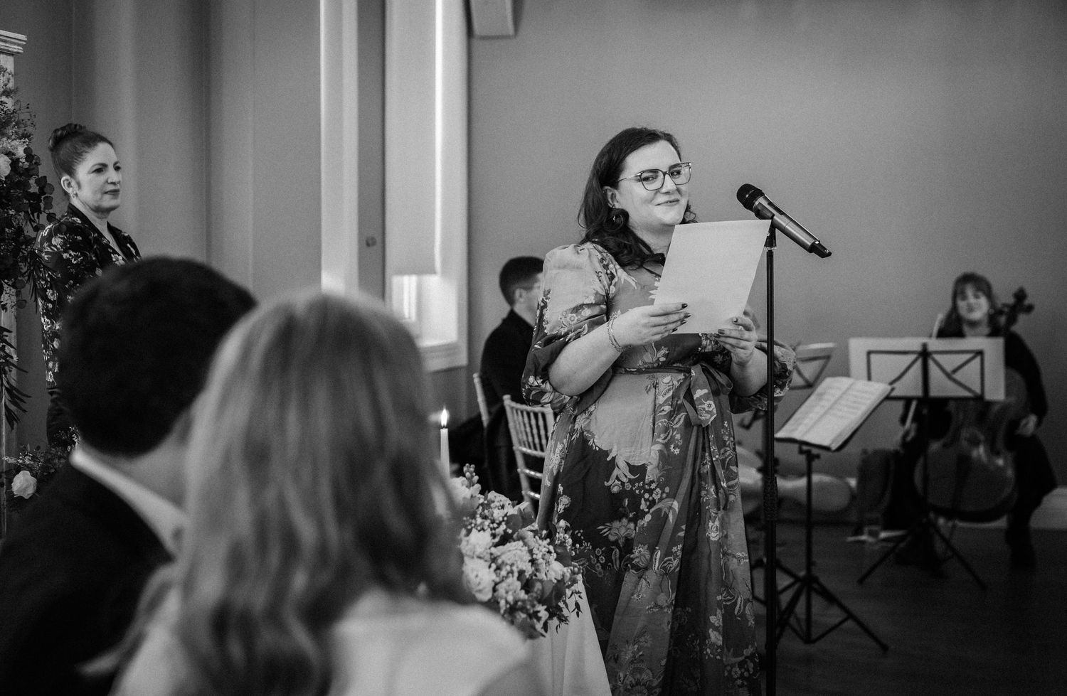 Black and white photo of musicians performing at an indoor event.