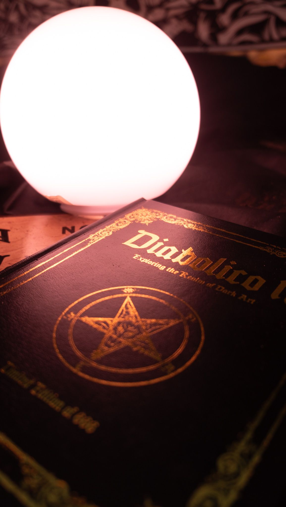 A row of dark book covers with illuminated spherical lights casting a warm glow on their surfaces.