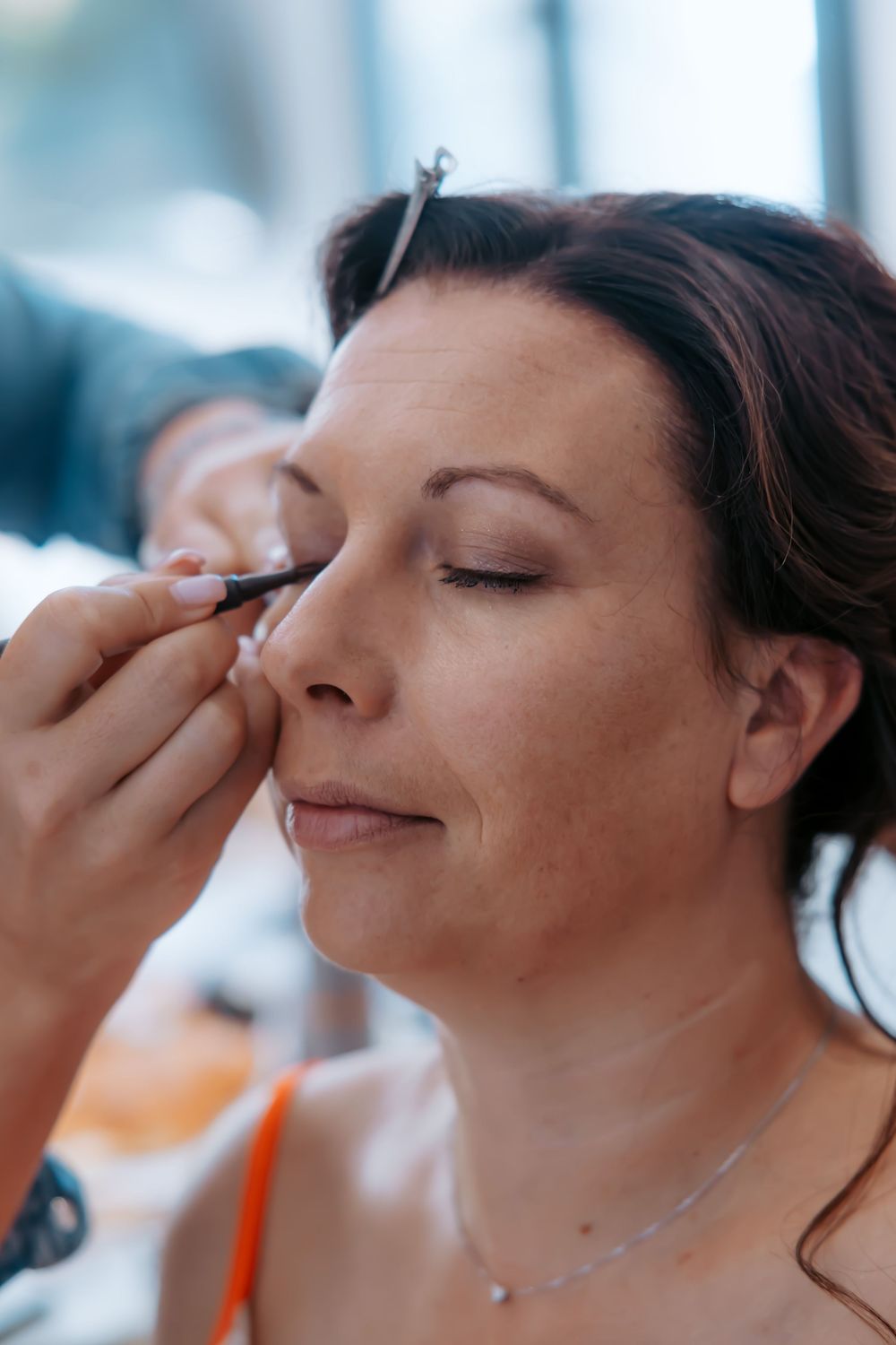 Close-up shot of wedding day makeup application in natural light.