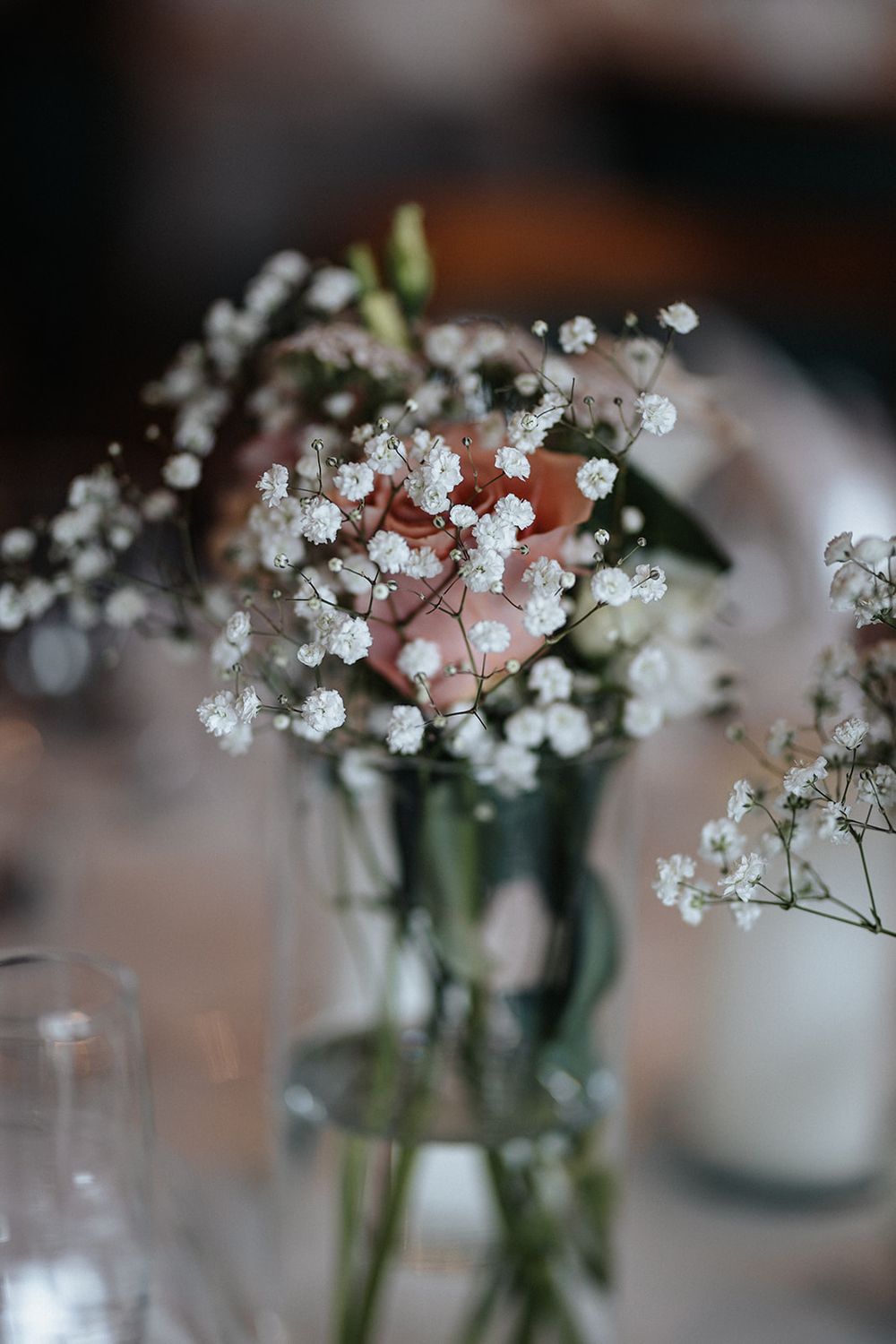 Delicate white baby's breath flowers arranged in small glass vases create an elegant table centerpiece display.