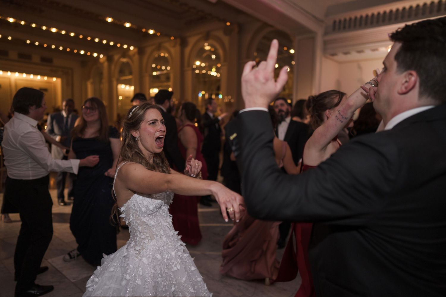 Energetic dance celebration in an ornate ballroom with warm lighting and classic architecture at The Westin Great Southern Columbus