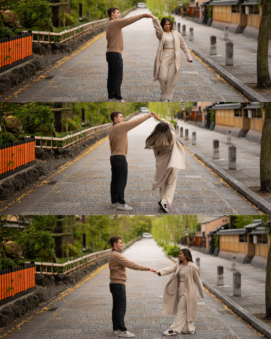 Couple dancing and spinning joyfully on a quiet tree-lined street in Kyoto, Japan.