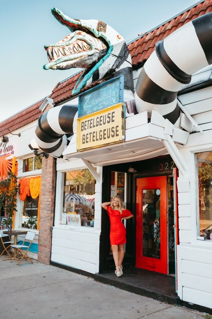 A row of vintage-style storefronts with retro signage and distinctive architectural details.