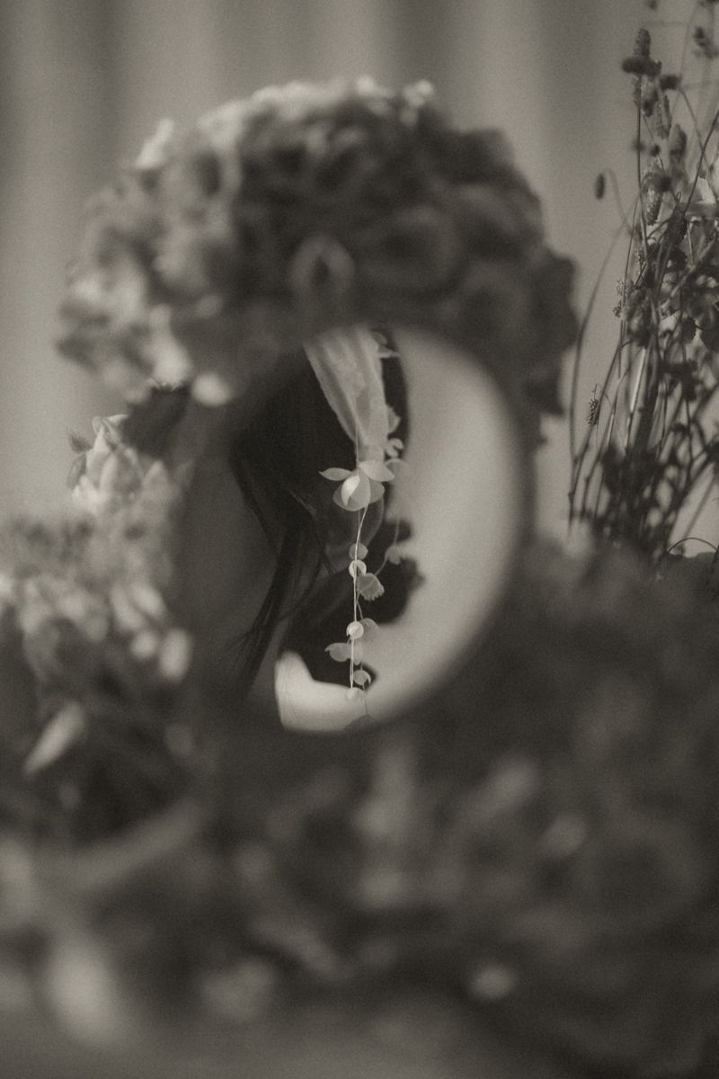 Black and white artistic photograph of delicate flowers with soft bokeh effect creating a dreamy atmosphere.