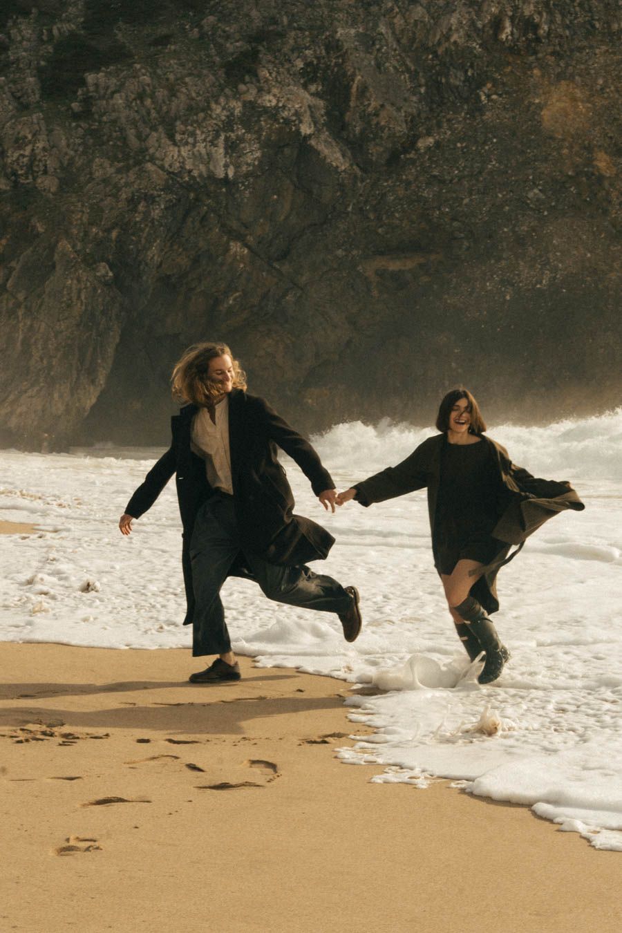 Couple running on the beach of Portugal