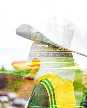 Double exposure photo of a golfer in yellow-green attire and white hat overlaid with a rainy outdoor scene.