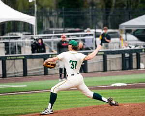 Oregon Ducks baseball pitcher #37 winds up for a pitch at PK Park during a college baseball game.