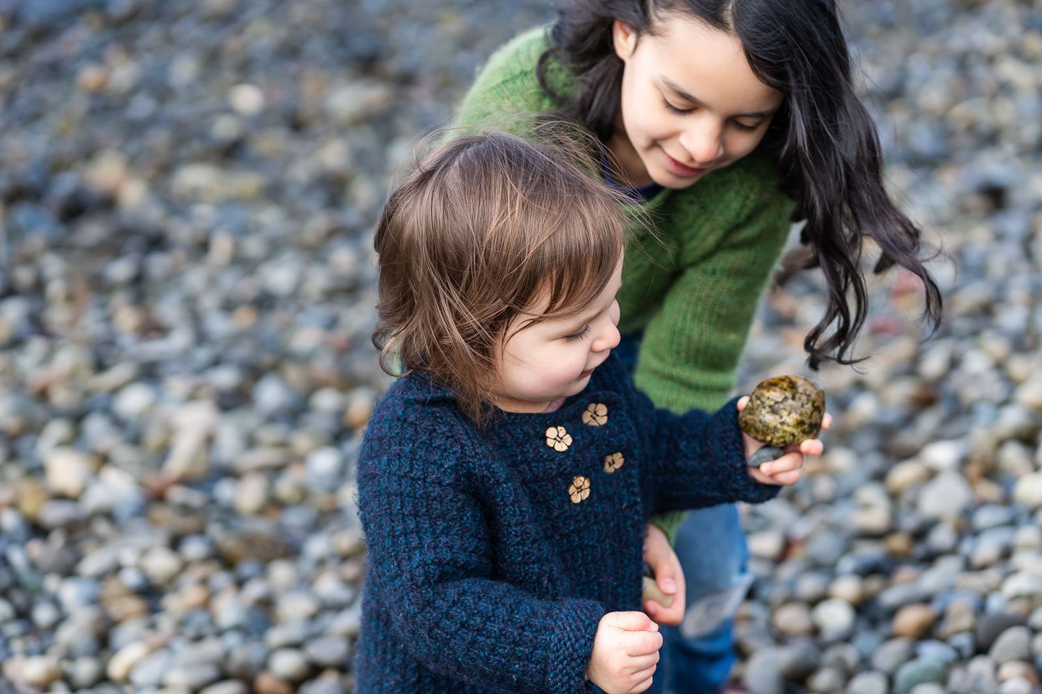 Children playing on a rocky beach.