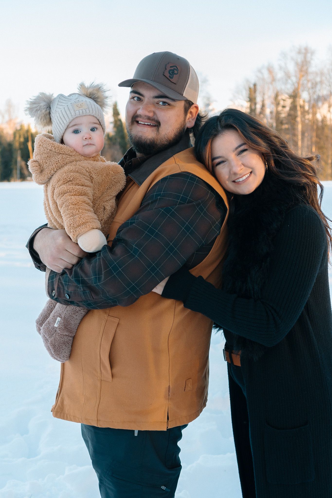 Adorable family of 3 enjoying a sunny winter day together
