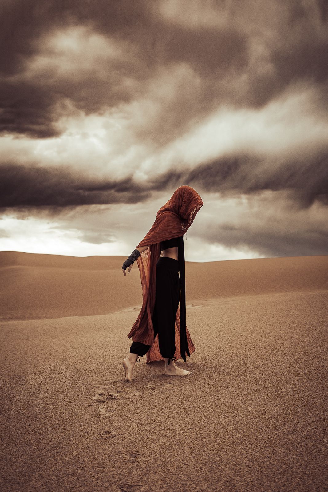 Outdoor editorial photography: woman on sand dune landscape