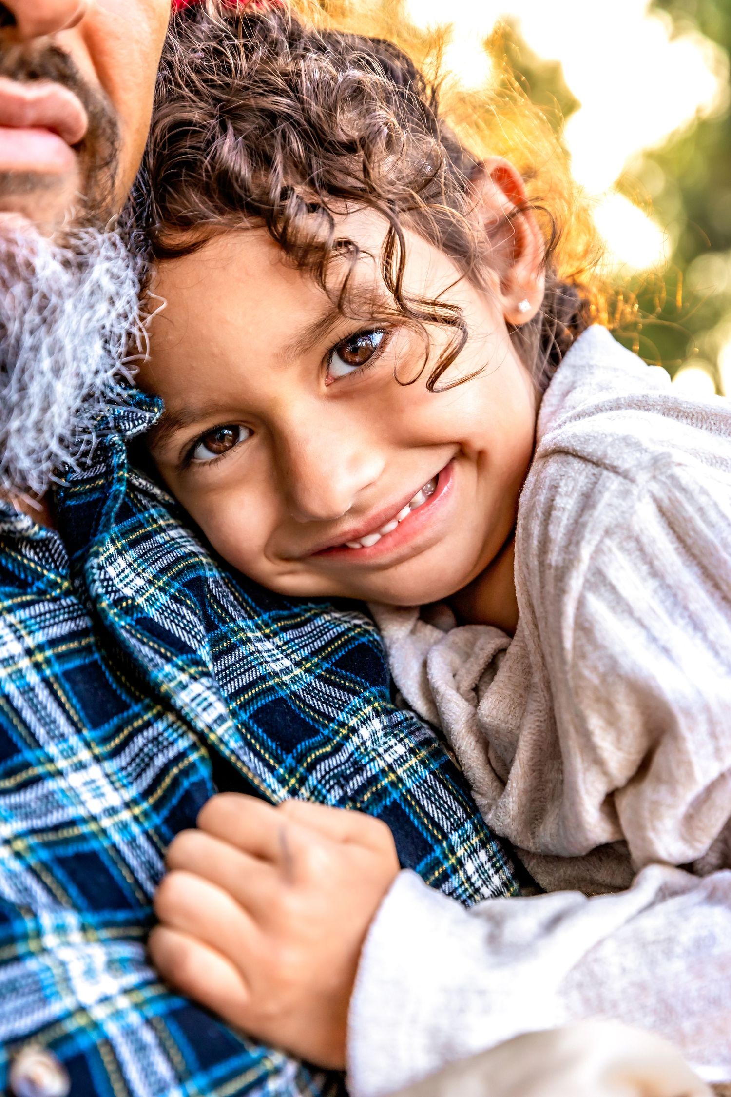 little one snuggles up next to daddy and realizes she is being captured by Clovis,ca photographer.