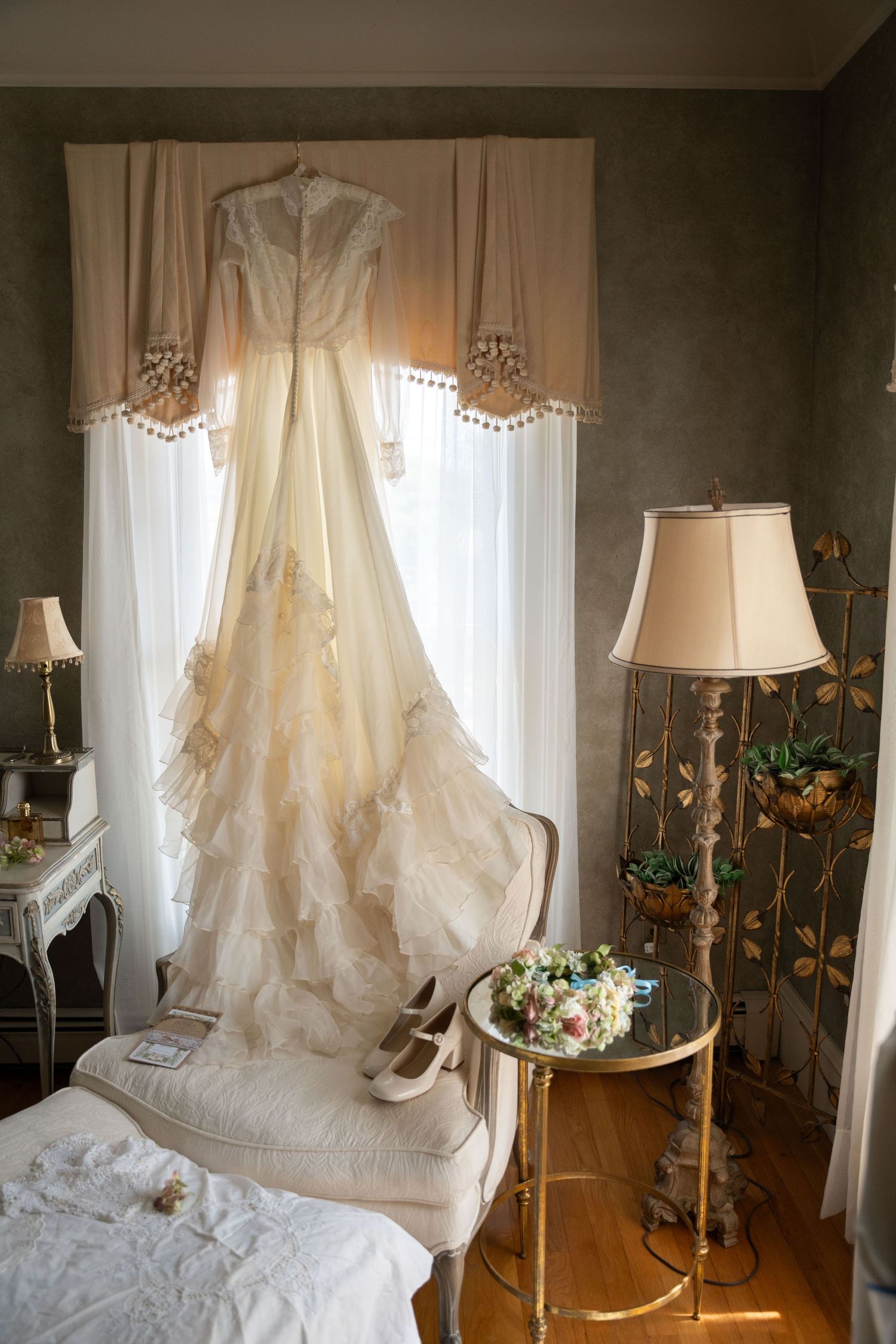 Elegant wedding dress hanging gracefully, with simple and light details, perfectly capturing the charm of a Cape Cod wedding.