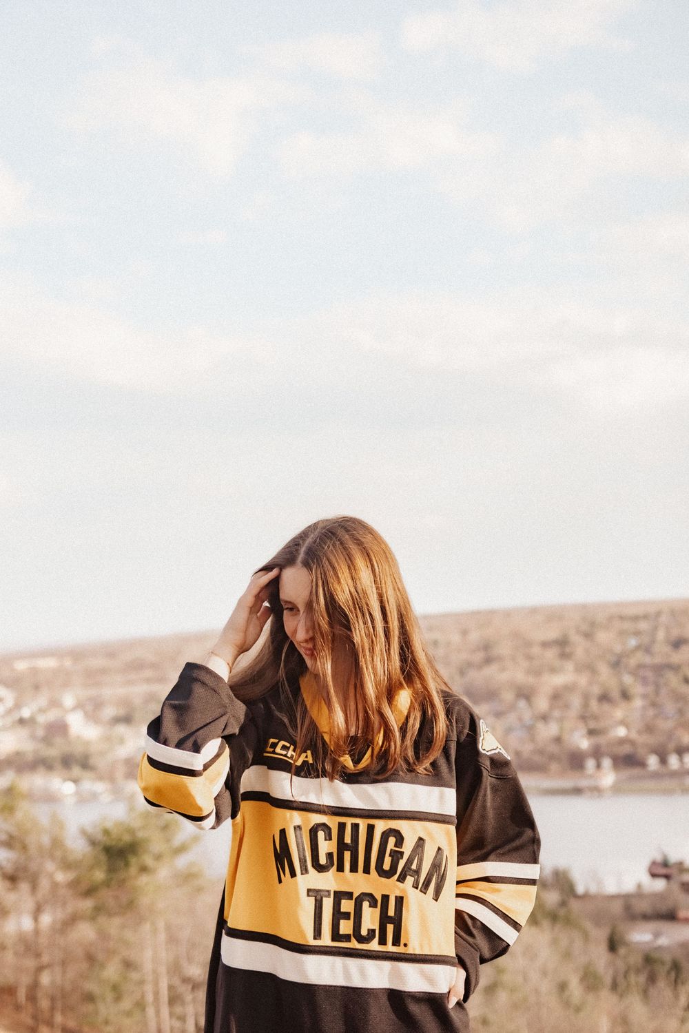 A Michigan Tech University student overlooking a spring landscape overview of Houghton, Michigan.