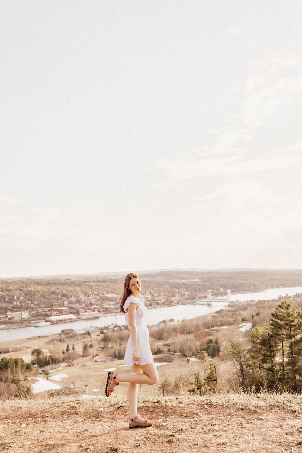 A scenic graduate photo session on Quincy Hill's hilltop overlooking waterfront towns of Houghton and Hancock, Michigan.