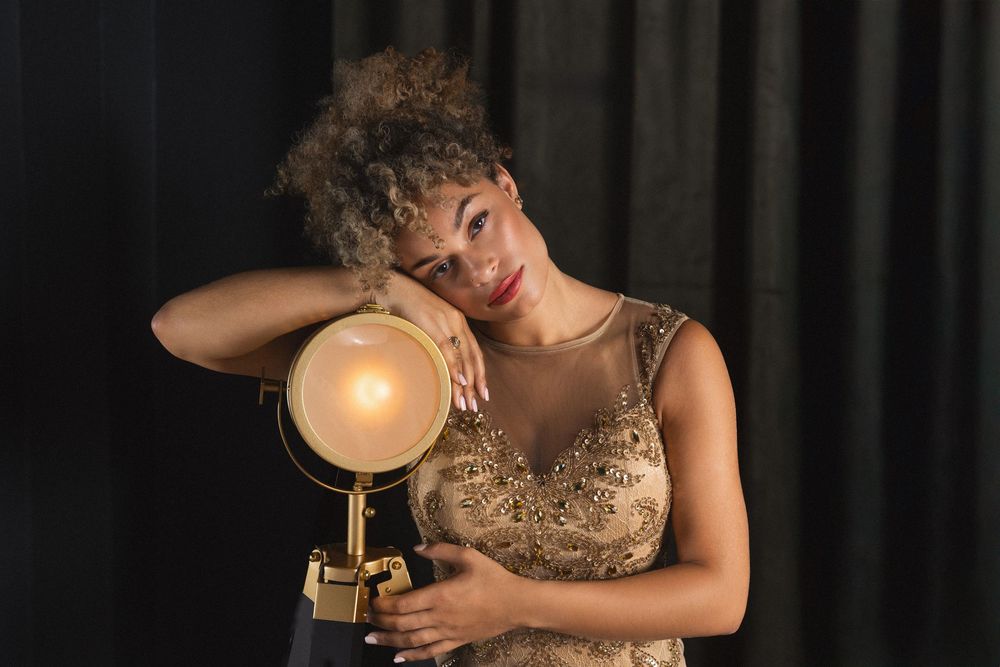 A sequence of photos shows a person wearing a gold dress posing with dramatic lighting and holding a glass of wine.