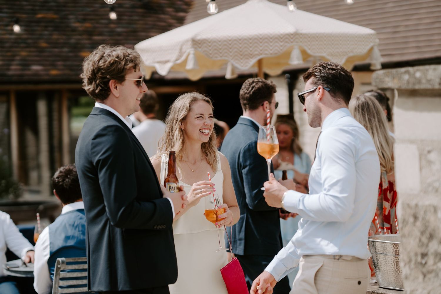 wedding guests enjoying drinks reception at wedding at yardspace old gore in cirencester
