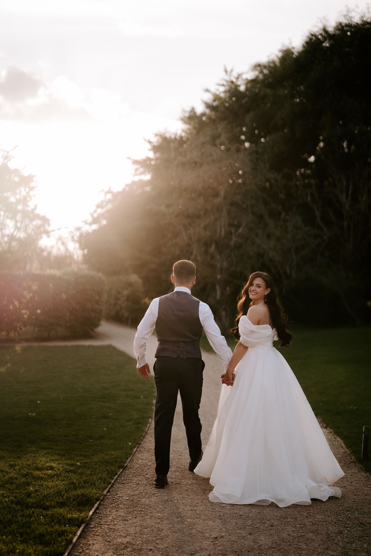 bride and groom walking into the sunset at yardspace old gore Cirencester