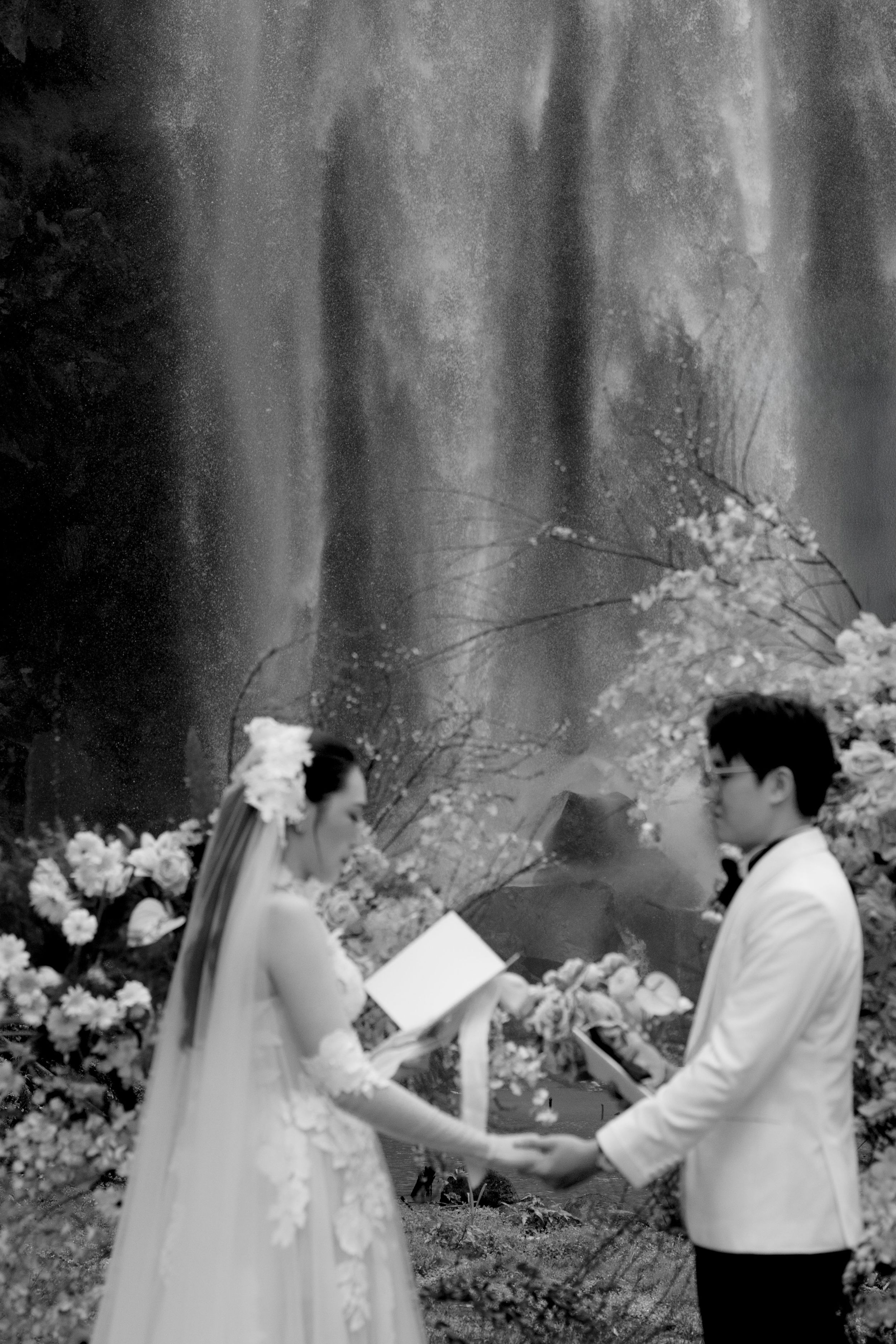Couple holding hands in front of Da Lat waterfal