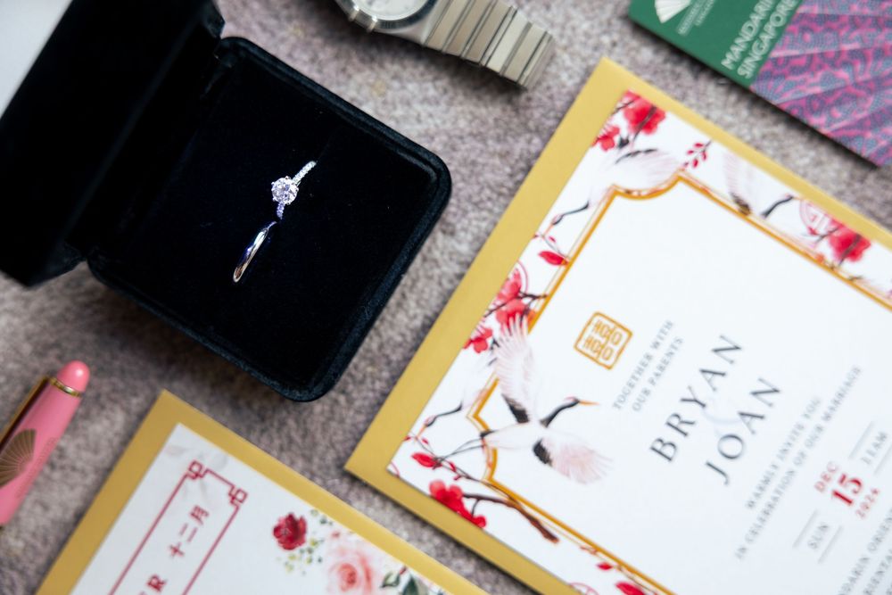 Stylish wedding invitations and cards displayed in a flat lay arrangement with floral designs and decorative borders.