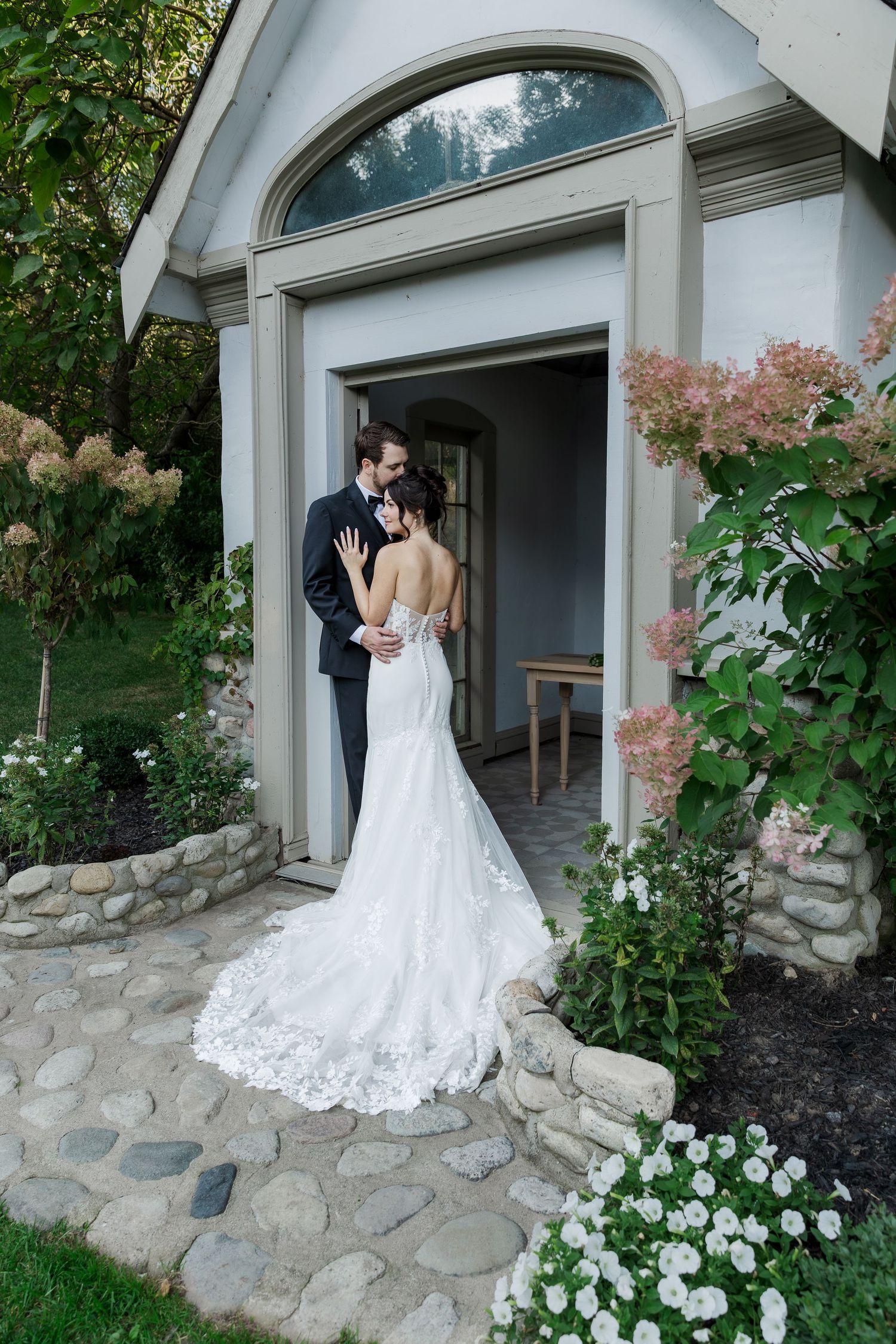 Elegant little chapel frames romantic wedding portraits in garden setting at The Wren House in St. Jacobs, Ontario.