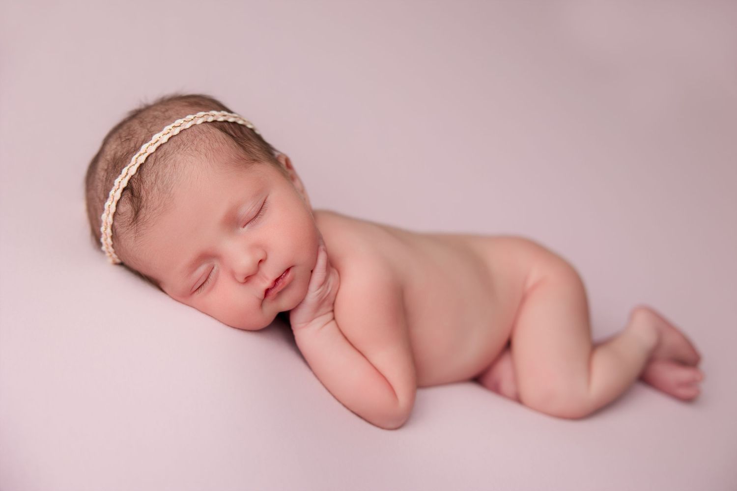 Professional photography collage showing sleeping newborn baby in soft pink setting.