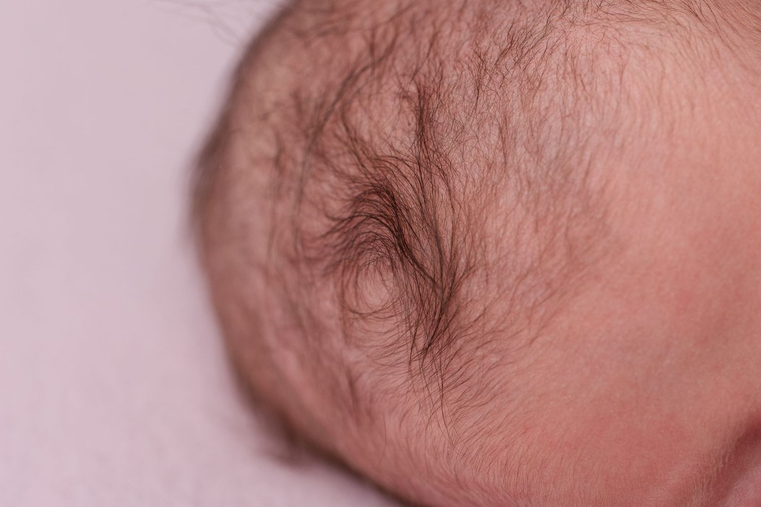 Close-up macro shots of sleeping newborn baby's face and features.
