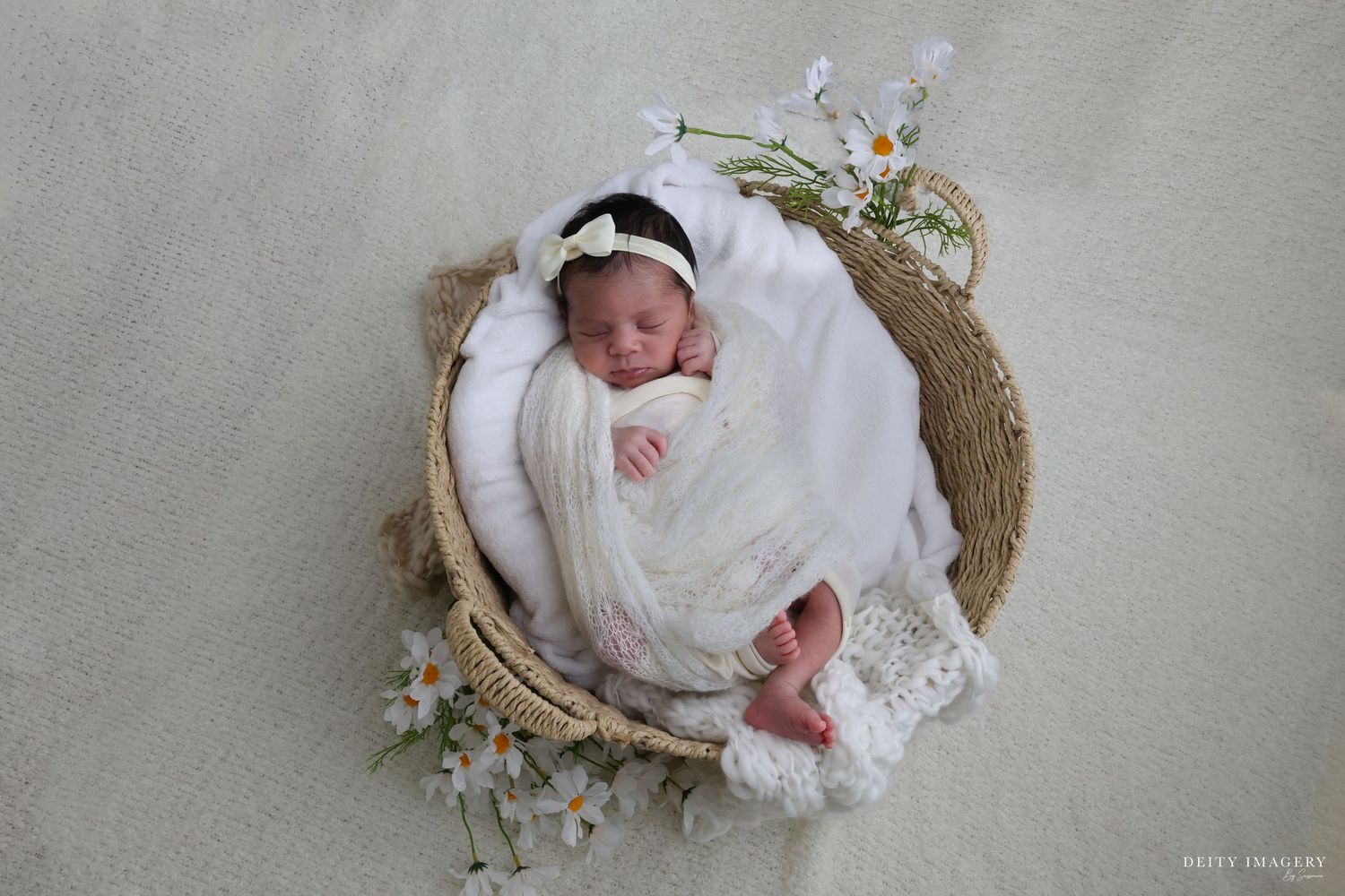A series of six newborn baby photos showing an infant sleeping peacefully in rustic woven baskets with soft white blankets.