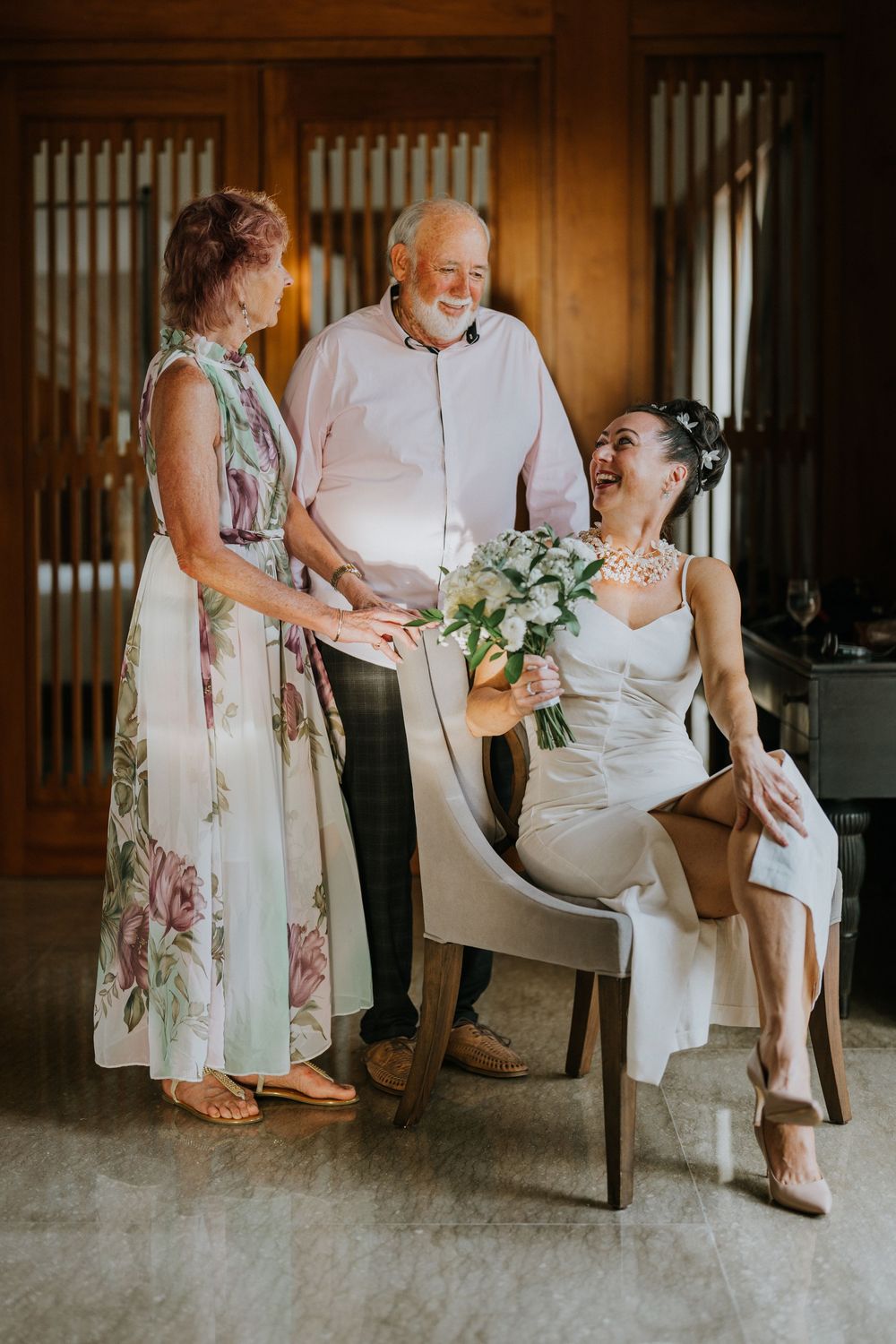 Candid moments shared between wedding party members in indoor venue setting.