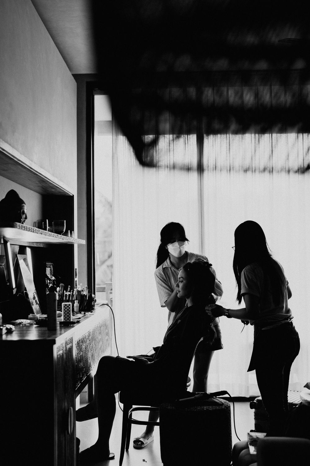 Black and white candid shots of wedding preparation in silhouette.