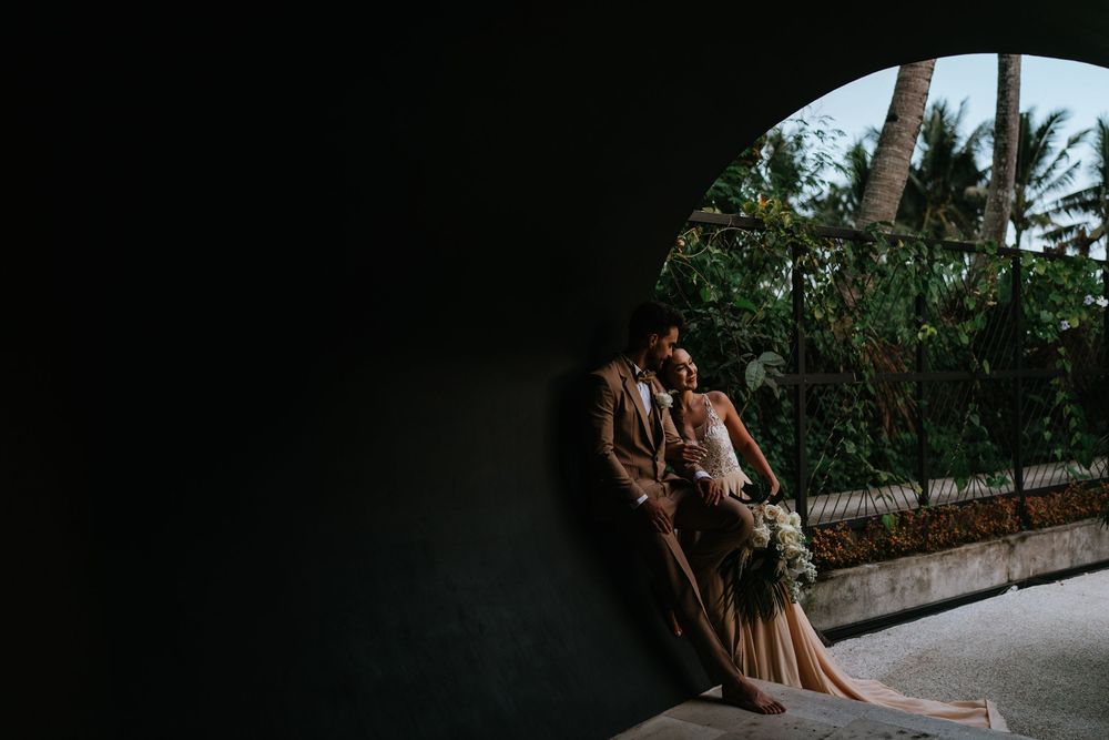 Intimate wedding moments captured in a dimly lit tropical garden setting.