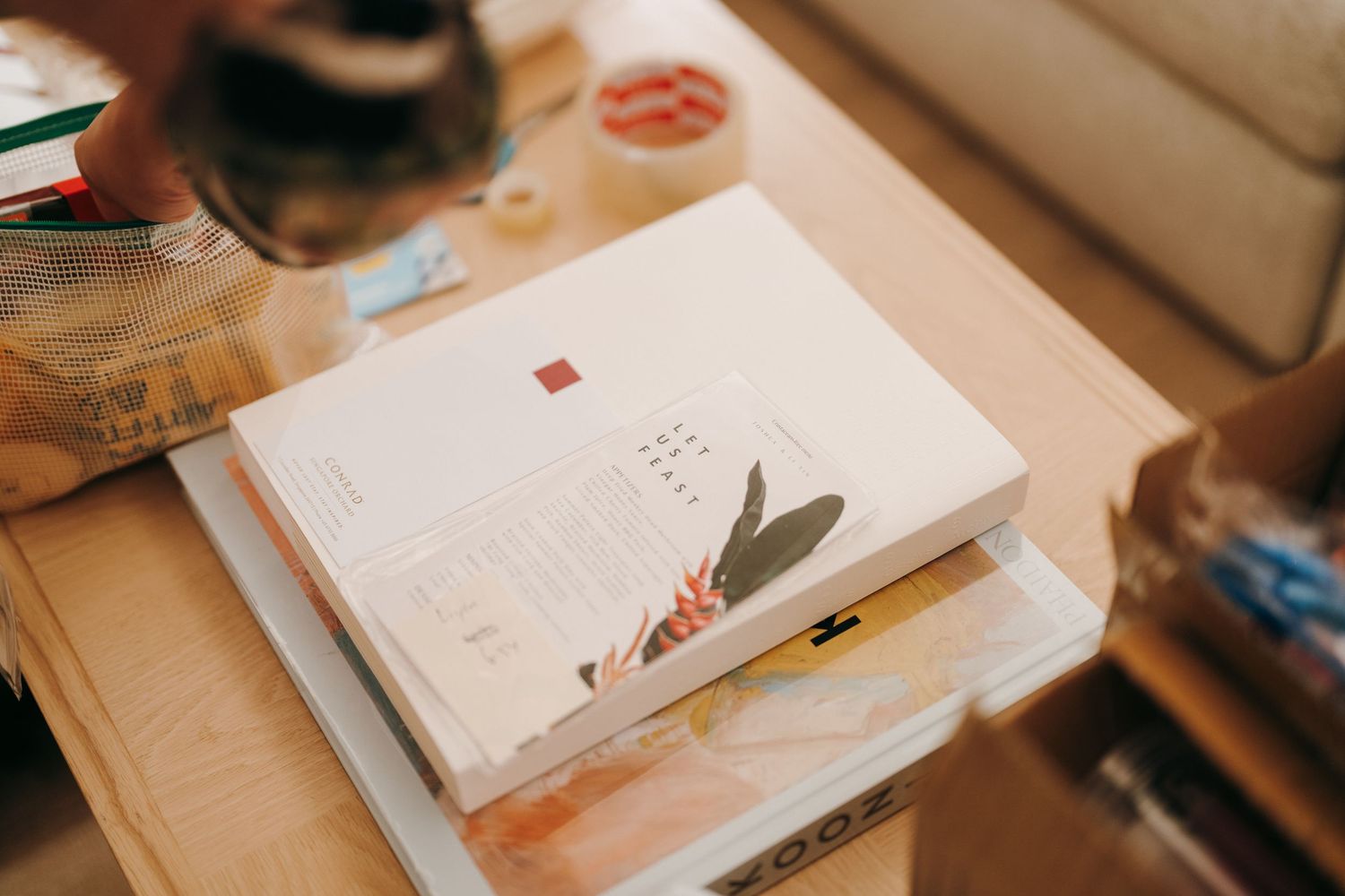 Open notebook with pen and stationery items arranged on wooden desk surface.