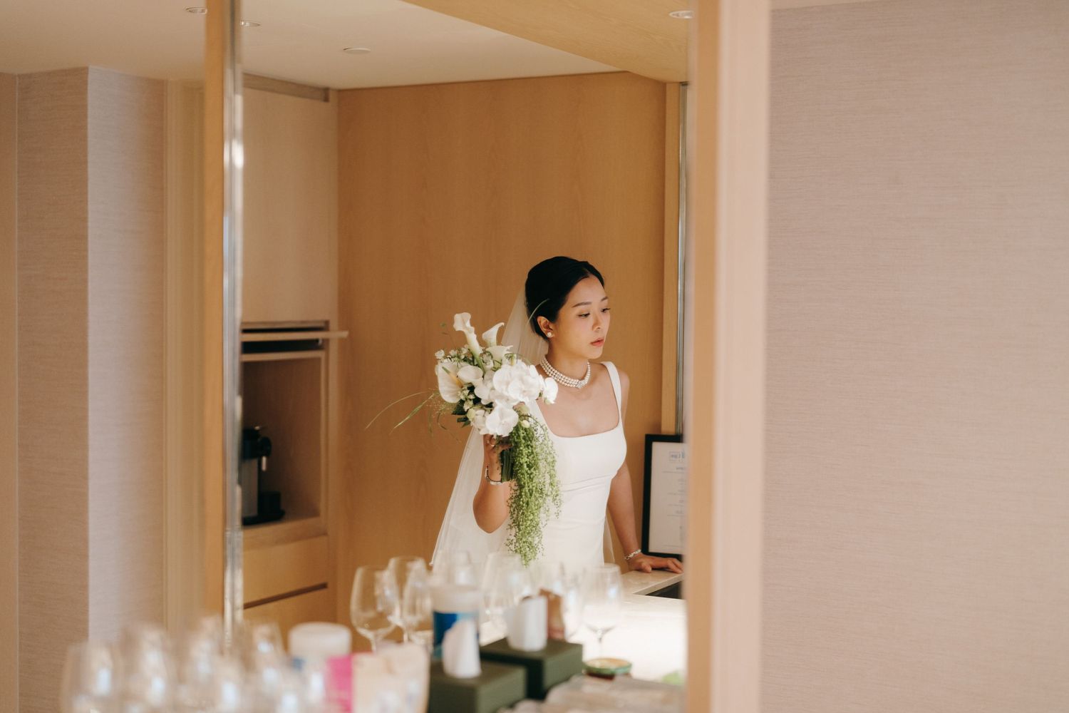 Elegant bridal scene with white flowers and soft interior lighting.