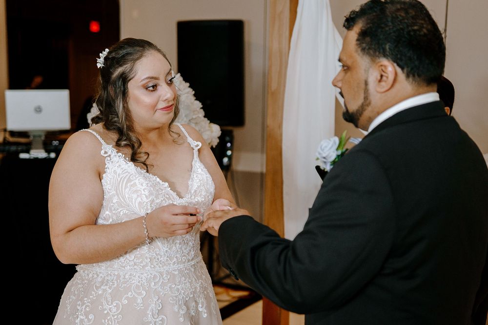 A couple shares an intimate dance moment during their wedding reception in an elegant indoor venue.