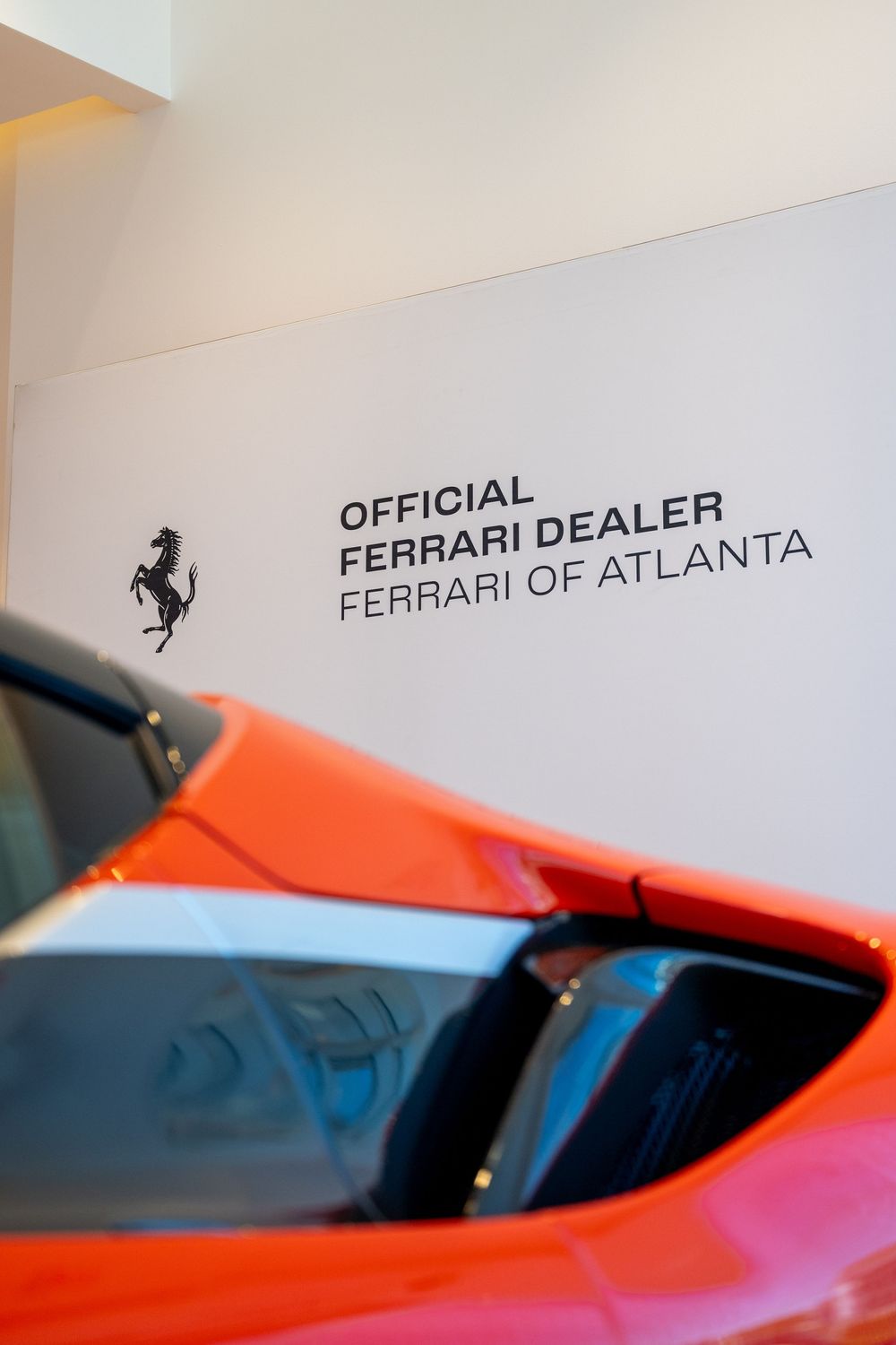 A bright red Ferrari automobile photographed at an official Ferrari dealership in Atlanta.