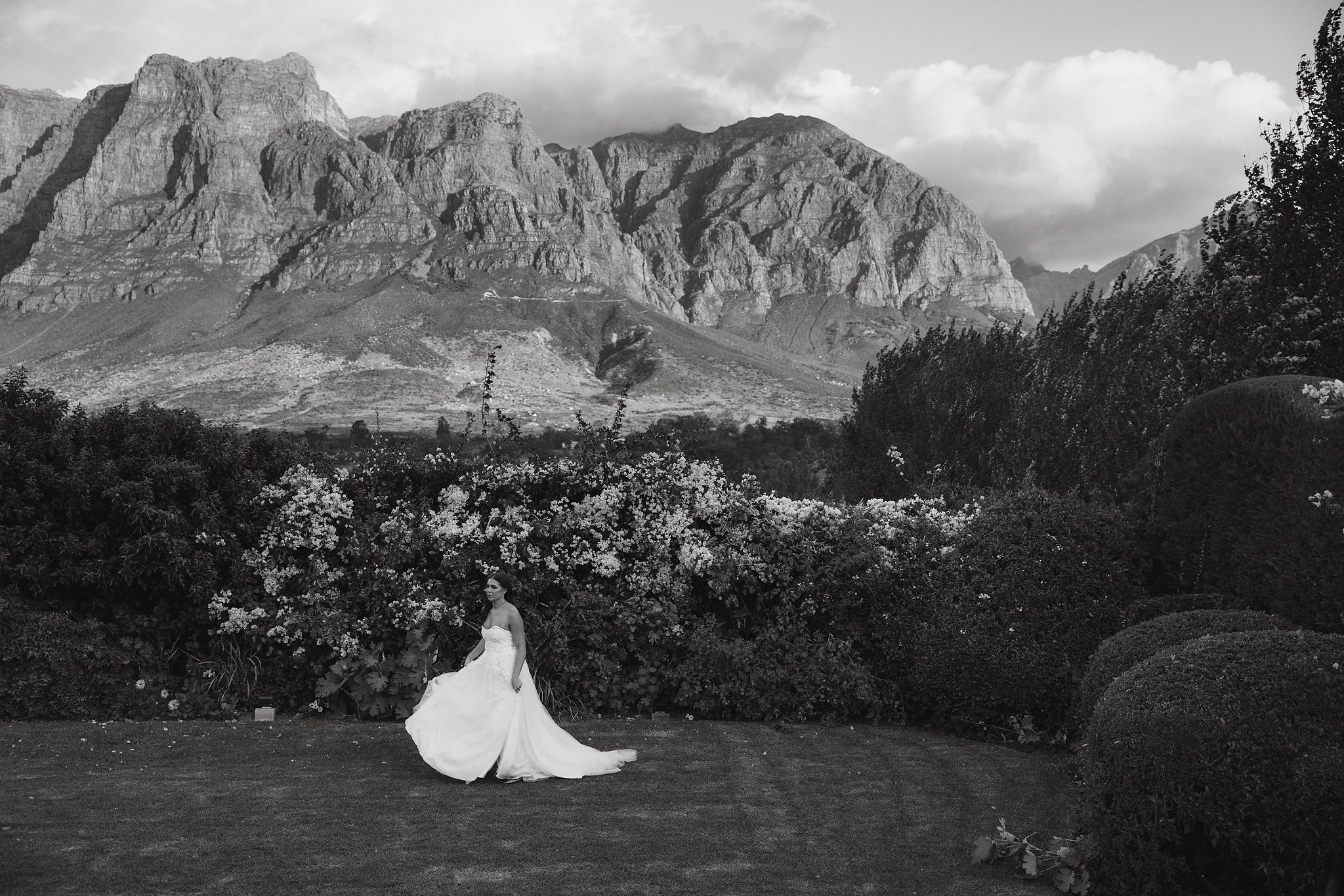 Bride walking through the gardens of Johannesdal 1207 wedding venue in Stellenbosch