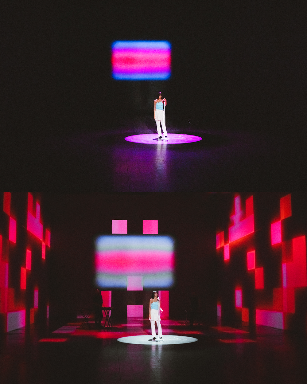 A figure stands in a dark space illuminated by dramatic red and blue lighting creating an ethereal stage-like atmosphere.