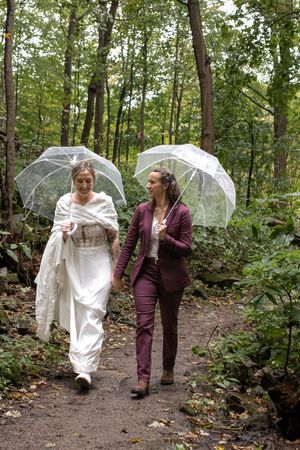 Two brides eloping at Sherman Falls Hamilton with intimate waterfall backdrop