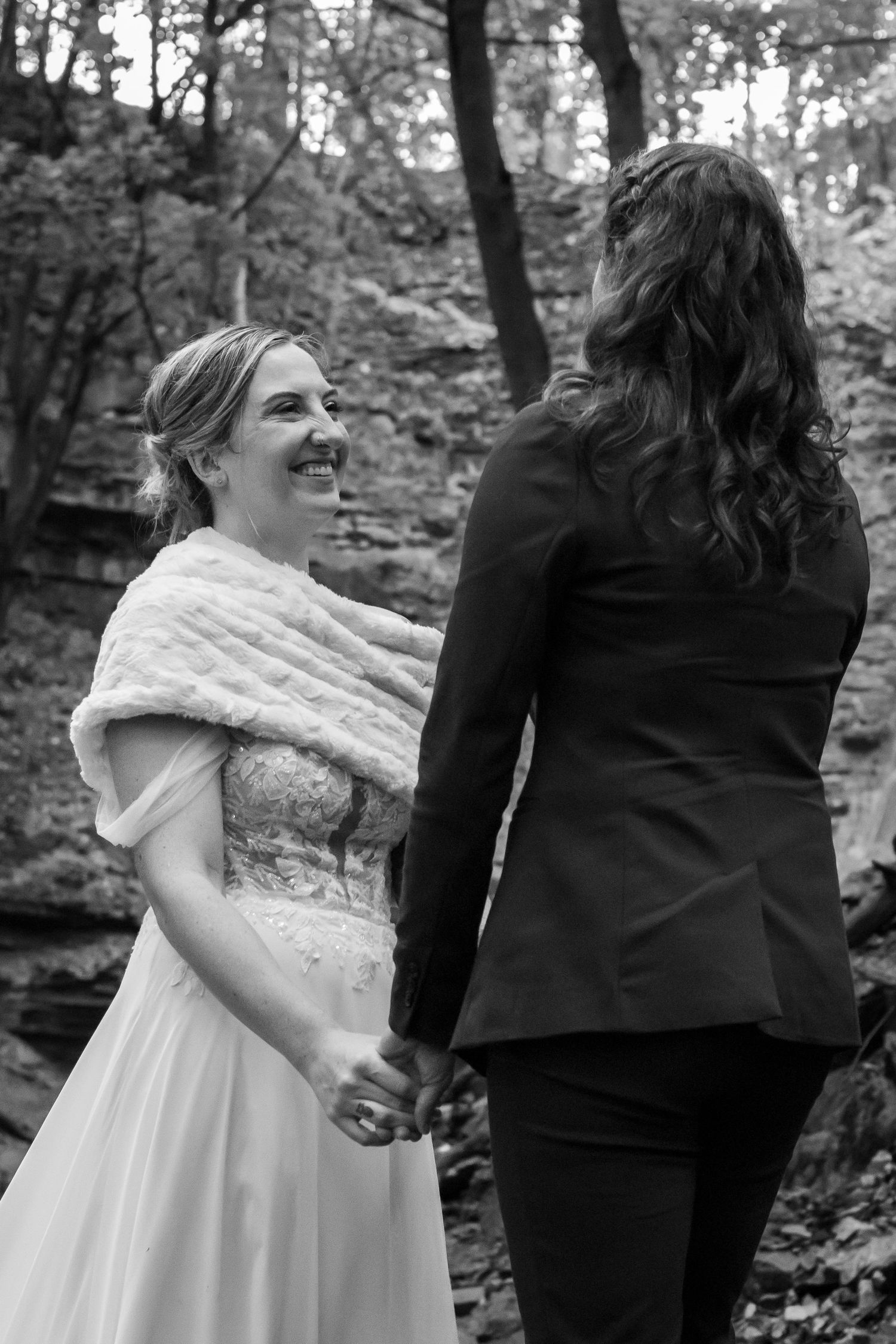 Same-sex couple eloping at Sherman Falls Hamilton with intimate waterfall backdrop