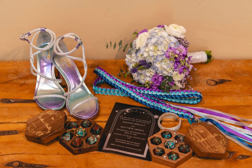 Tea party setting with vintage cups, cookies, turquoise crochet items, and chalkboard signs arranged on wooden surface.