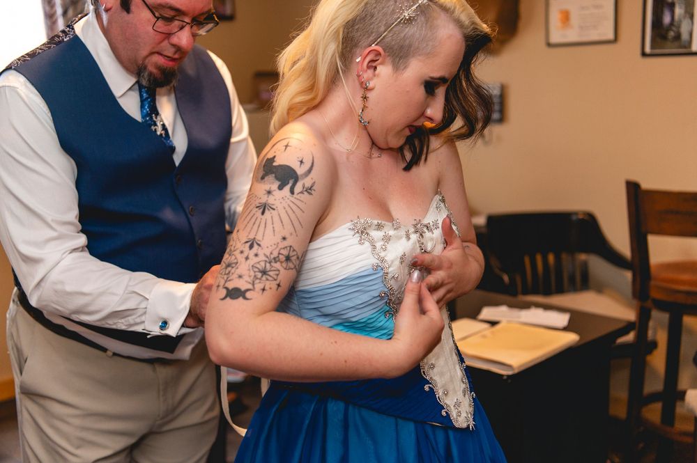 A tender moment at a wedding reception with a couple sharing an intimate dance in their formal attire.