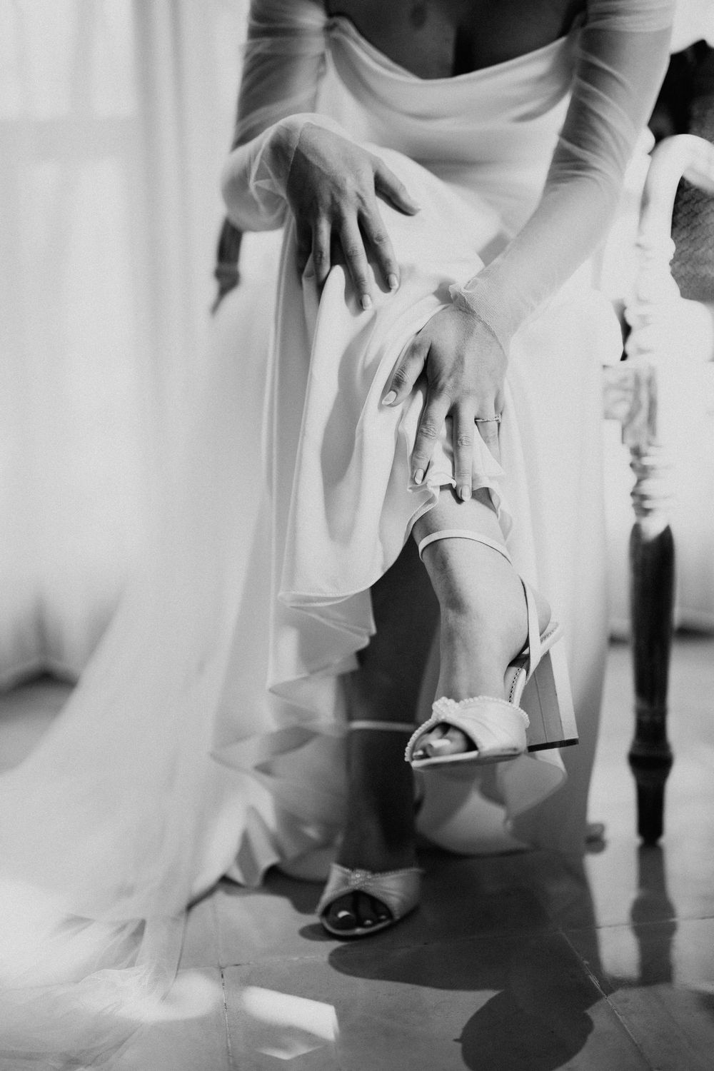 Close-up shots of bridal shoes being put on before the ceremony.