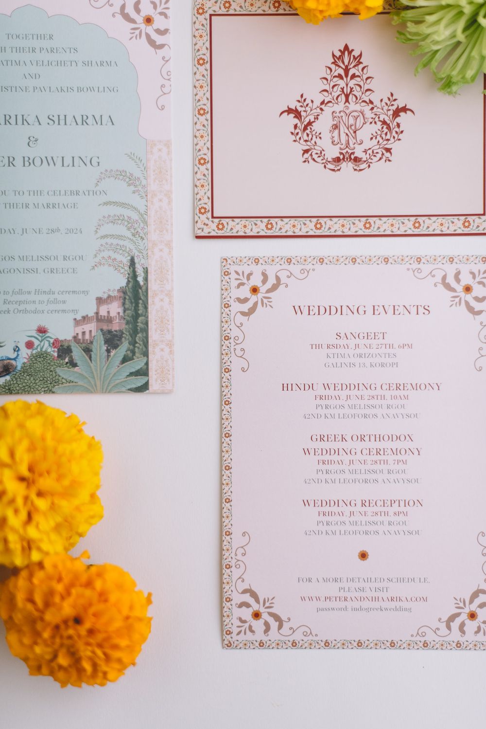 Elegant wedding invitation suite with rose gold floral designs and marigold flowers against a light background.