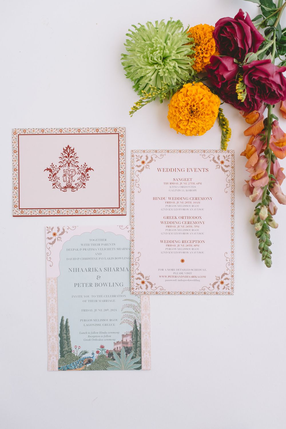 Elegant wedding invitation suite in pink and white with floral designs and colorful flowers as decoration.