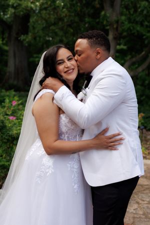A romantic series of wedding photos showing a happy couple embracing and kissing in a lush garden setting.