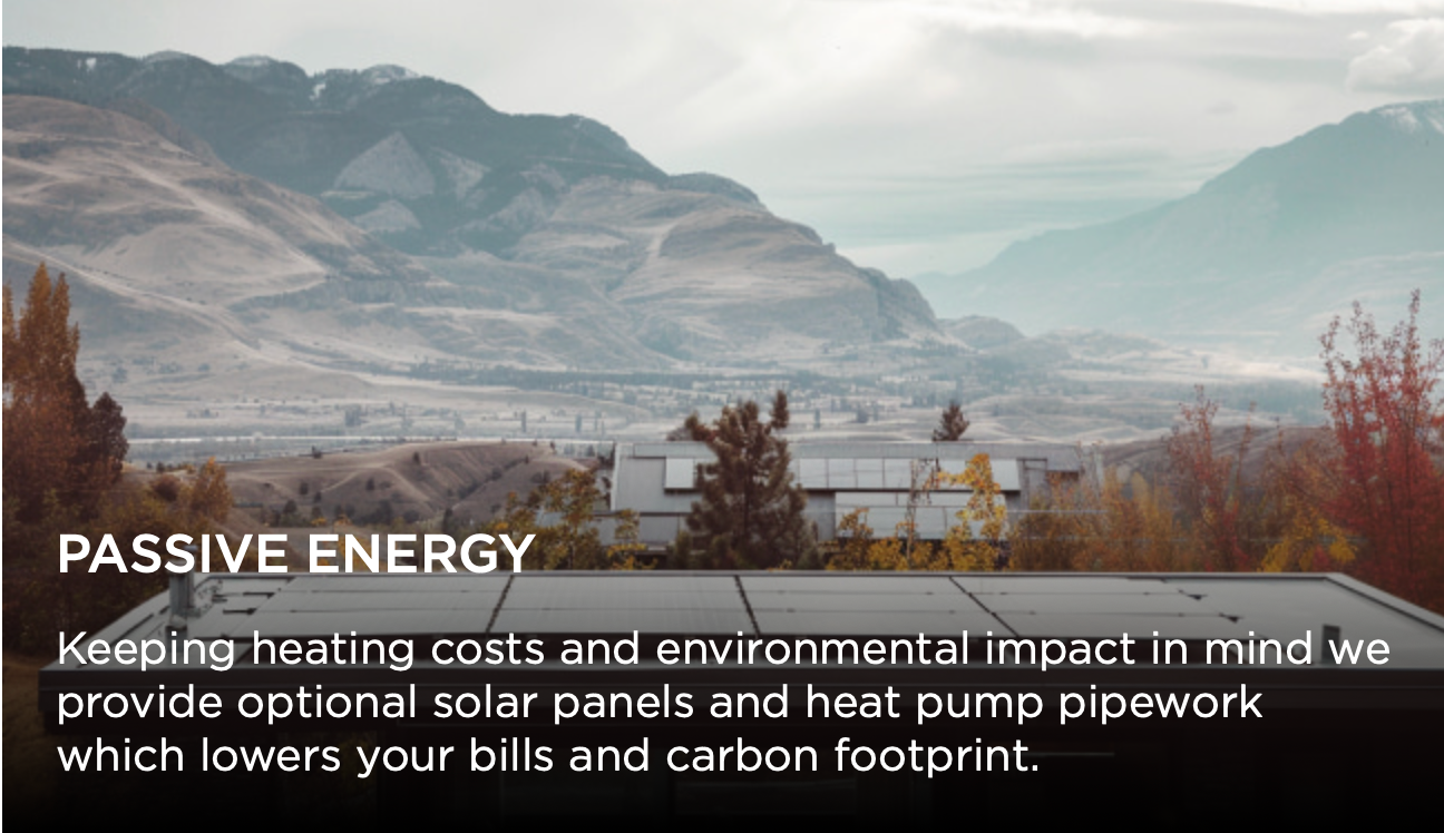 Scenic mountain landscape with architectural elements showcasing passive energy design features and solar panels.