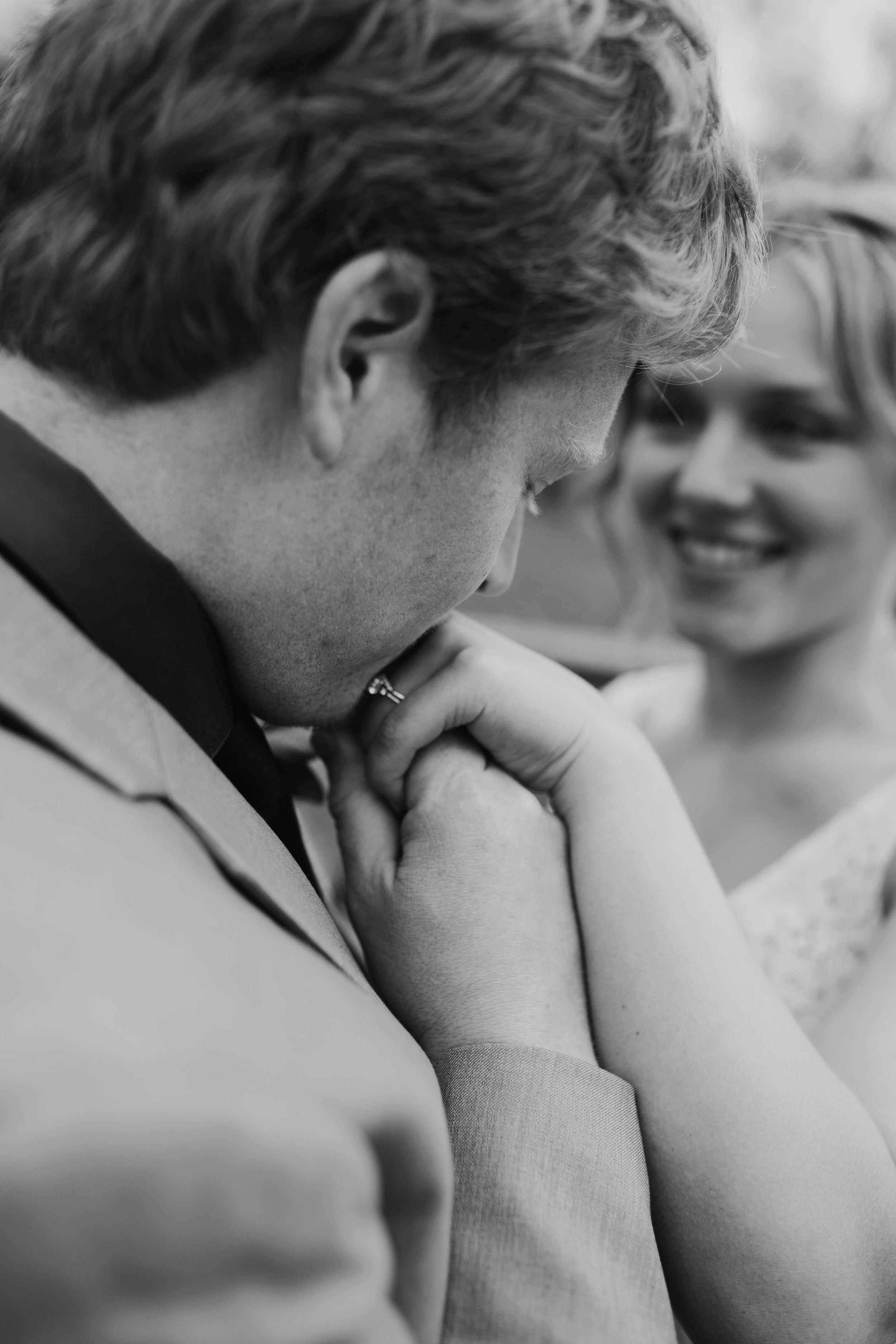 Intimate black and white wedding moment captured in natural light.