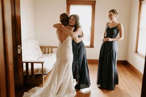 Wedding dress fitting scene with navy blue bridesmaid dresses.