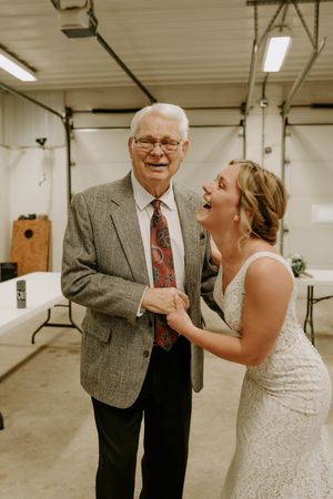 Emotional wedding moment captured in a basement venue with joyful expressions.